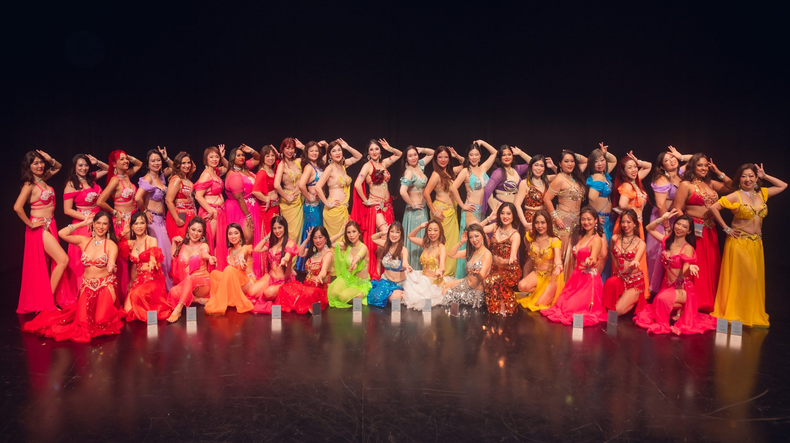 Group of people performing dance on stage. Group of people performing dance on stage.